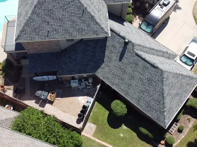 Aerial view of a gray shingle roof replacement in Highland Village, TX