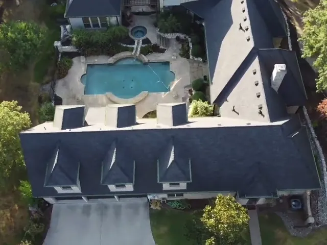 Aerial view of a black shingle roof on a Flower Mound, TX home
